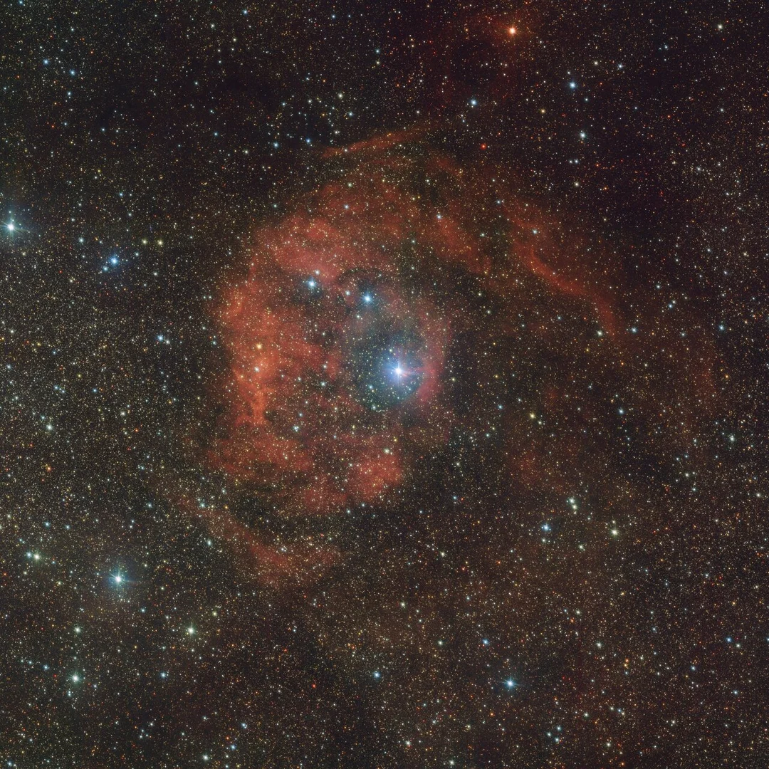 ‘Cosmic Imposter’ Star Lights Up Distant Nebula in Fiery Red Glow: A Stellar Whodunit